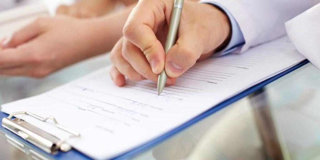Hand,Of,Doctor,With,Pen,Writing,On,Prescription,Blank